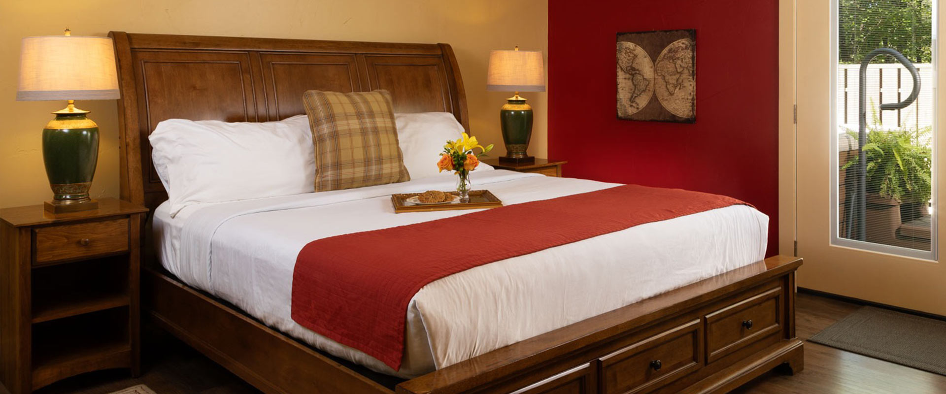 Picture of the bed in the Bruce Croft at Glenlaurel, with a tray of cookies and flowers.