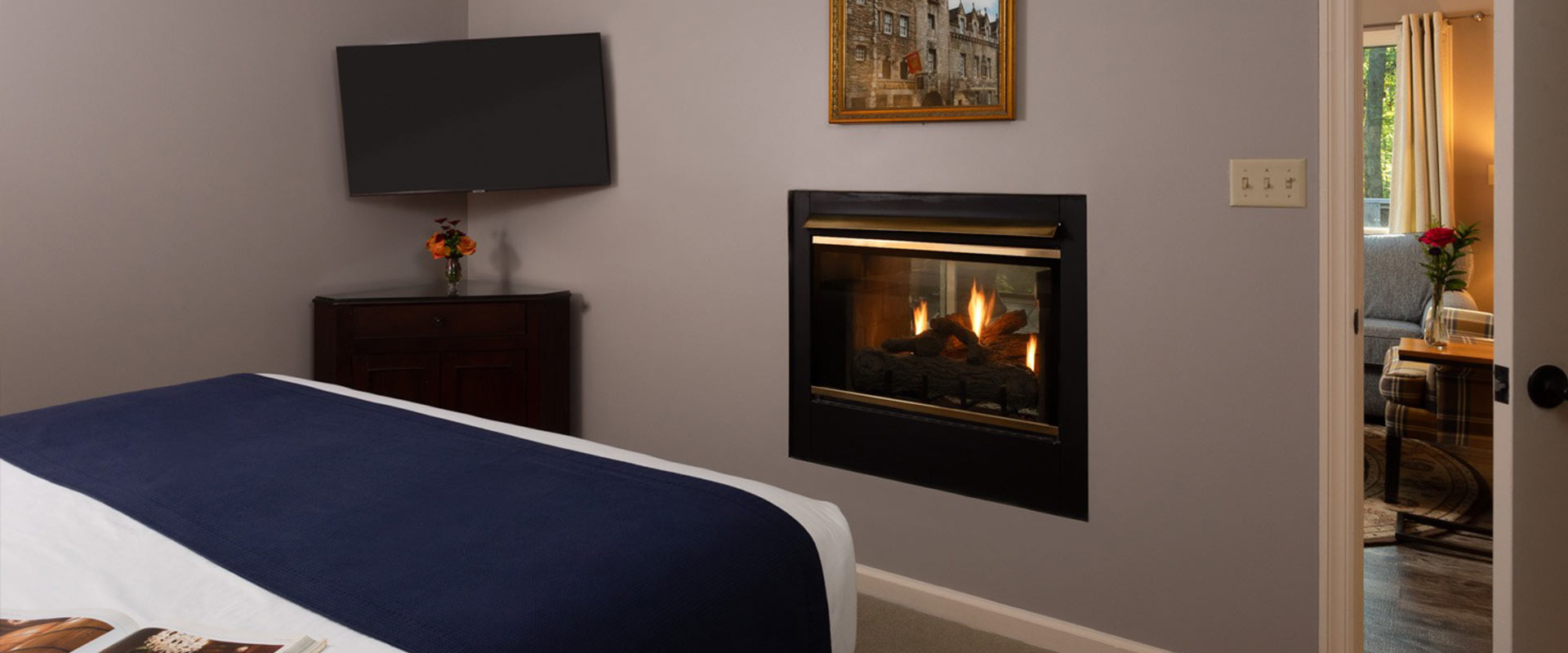 Picture of the bed, TV, and fireplace at the Drummond Croft at Glenlaurel.