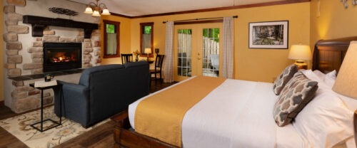 Picture of the bed, couch, and fireplace at the Gordon Croft at Glenlaurel.