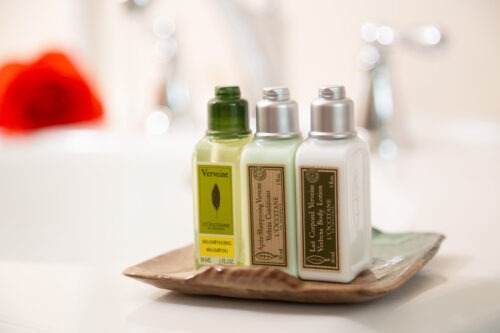 Mini toiletries, including shampoo, conditioner, and body lotion.