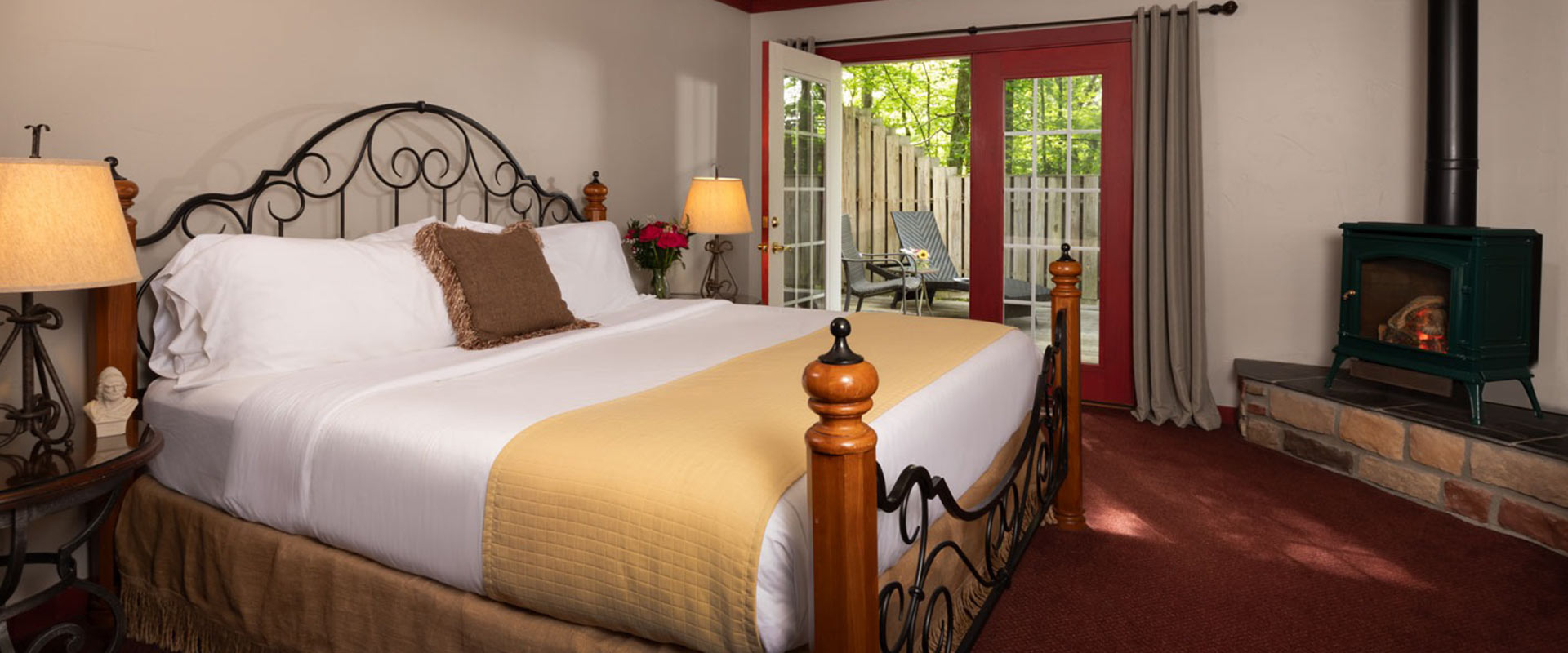 Picture of bed and fireplace in the Wallace at Glenlaurel.