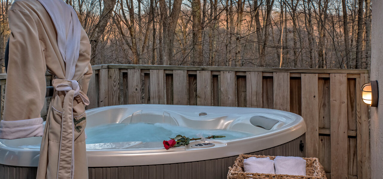 Picture of a hot tub, red rose, towels, and robe in the MacDougal Croft at Glenlaurel.