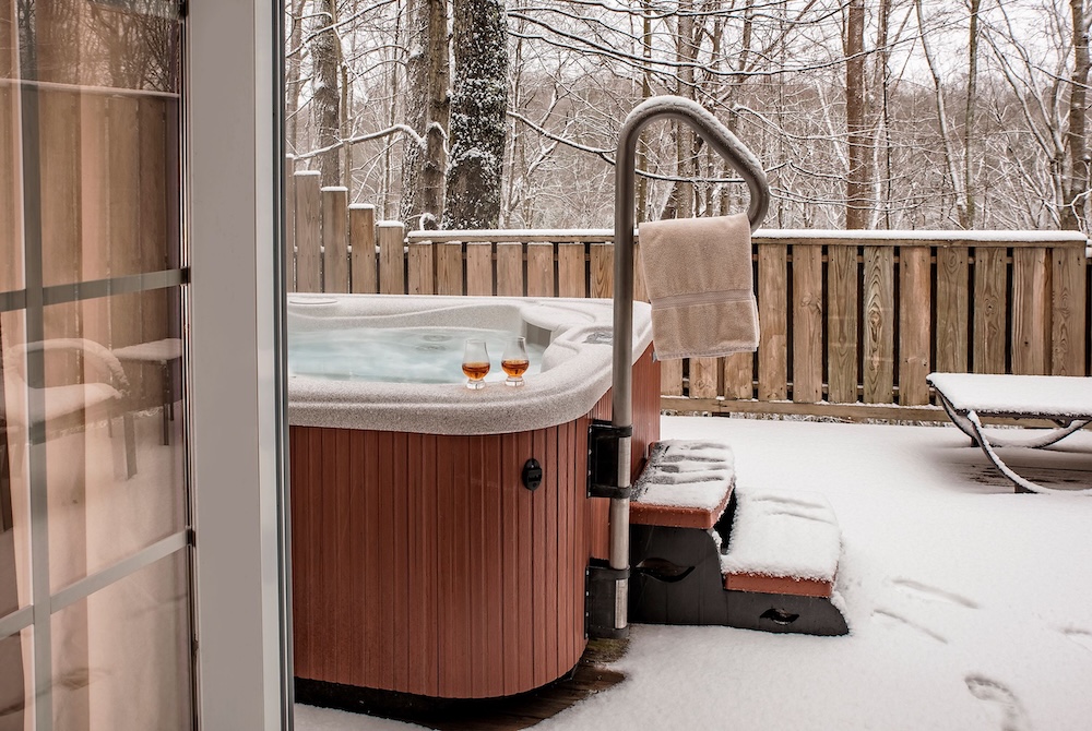 Hot tubs in the snow at our getaway cabins in Hocking Hills