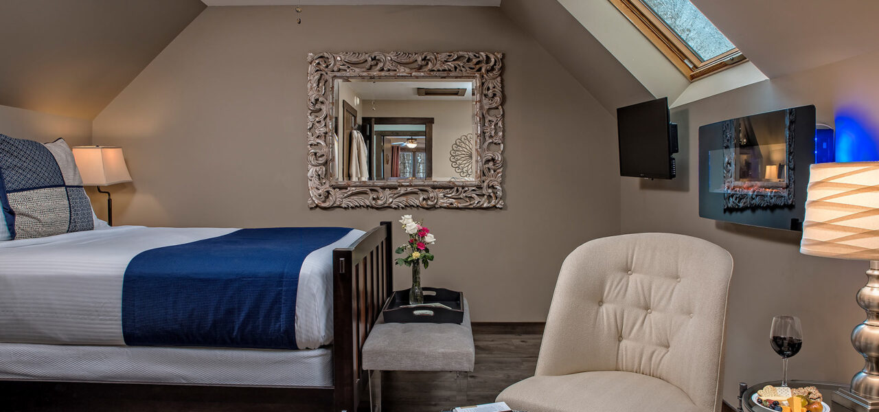 Picture of bed, chair, TV, and fireplace in the Mar at Glenlaurel.