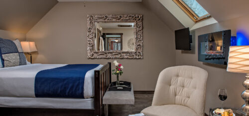 Picture of bed, chair, TV, and fireplace in the Mar at Glenlaurel.