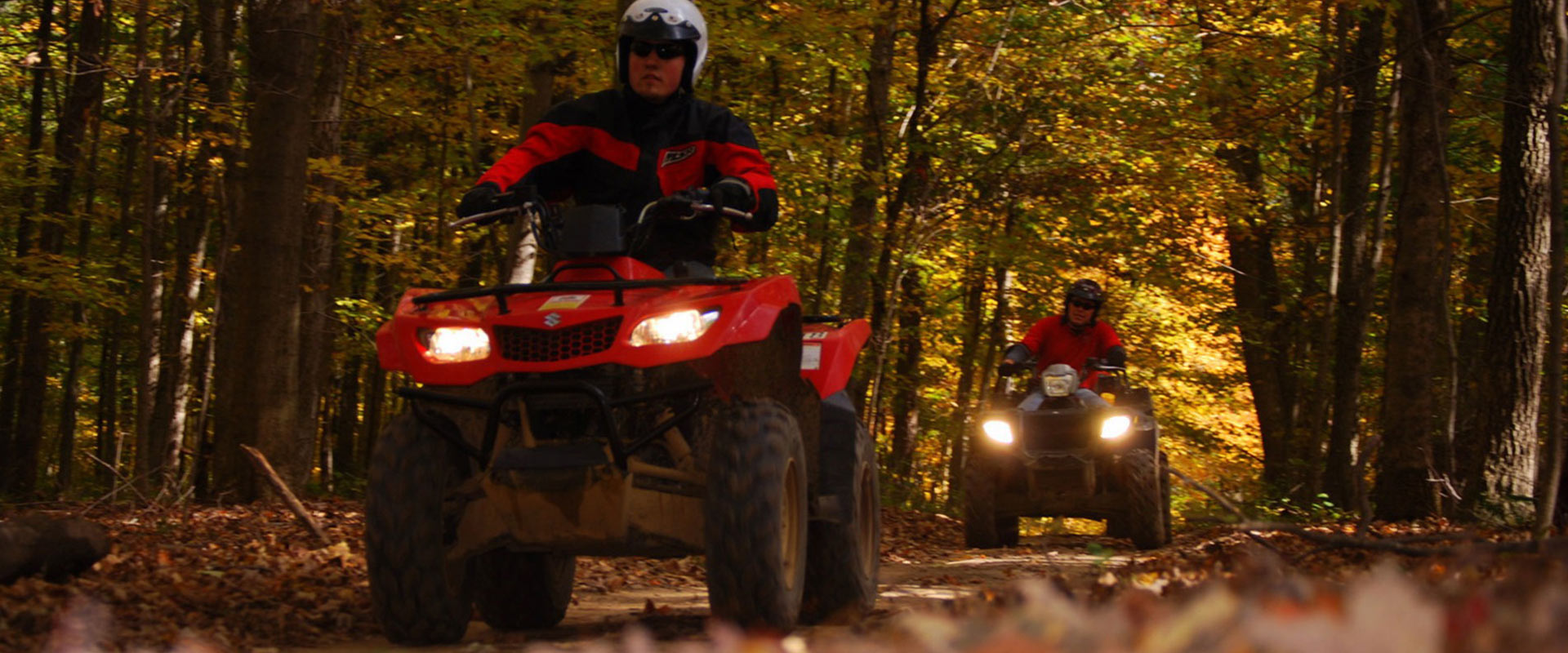 Two people ATVing in the fall.