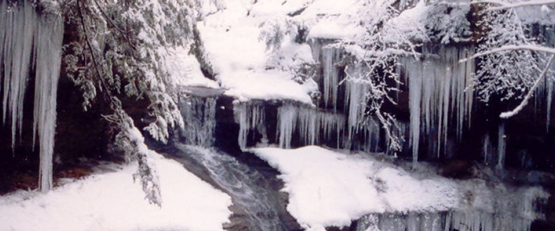 Frozen waterfall, with snow on top.
