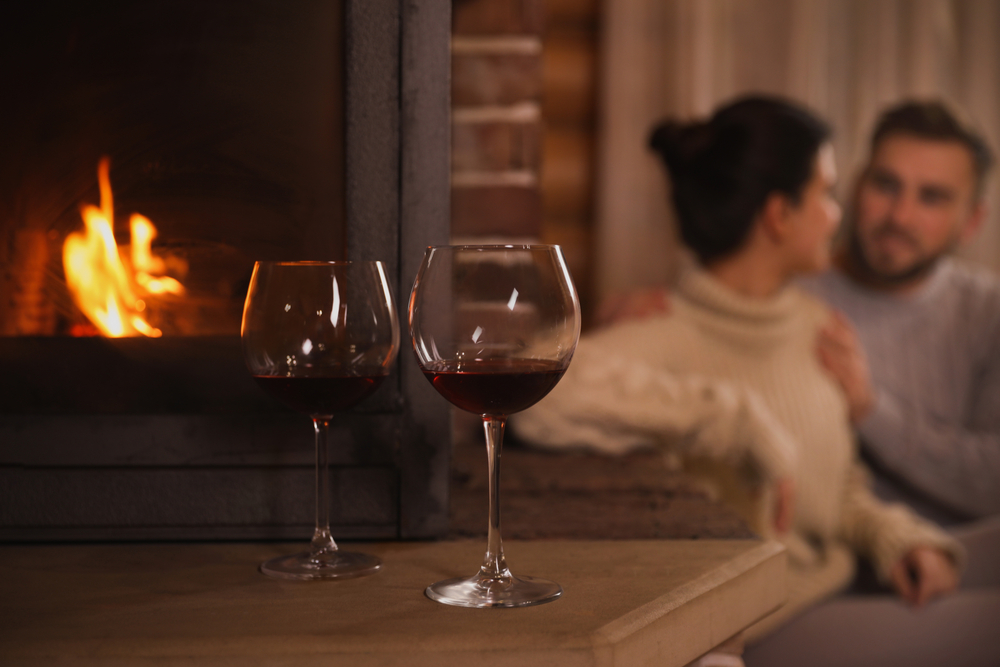 couple drinking wine by the fire during their Valentine's Day getaway at our getaway cabins in Hocking Hills