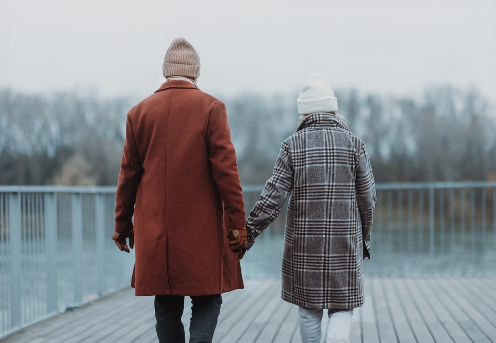 Senior couple walking in the winter during their Valentine's Day getaway in Hocking Hills, Ohio