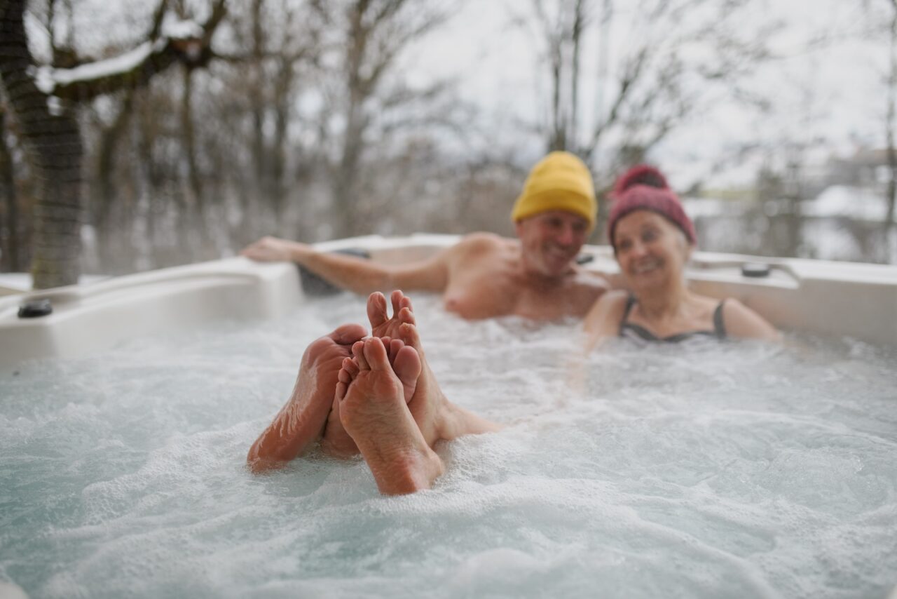 senior couple enjoying a winter afternoon in the hot tub during their Hocking Hills romantic getaway